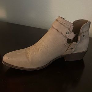 Beige cowboy style booties.